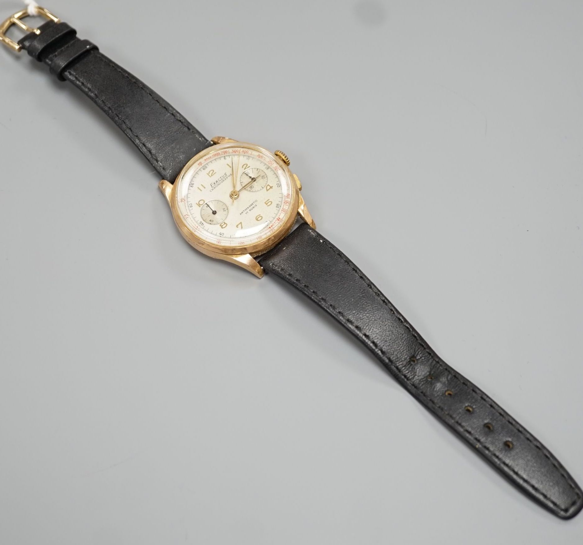A gentleman's 1950's? 18k yellow metal Exactus manual wind chronographe wrist watch, on a black leather strap, case diameter 37mm